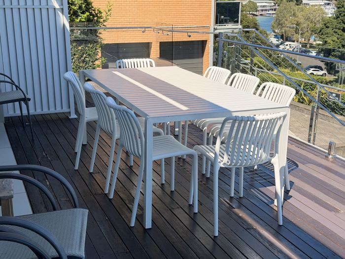 Outdoor dining table and chairs on Riviera's gated deck